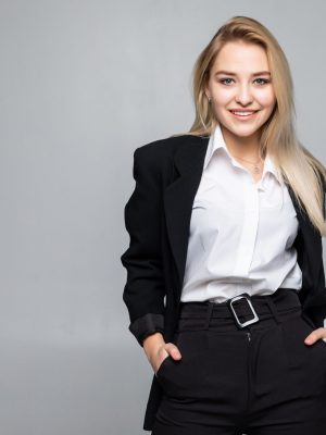 Young woman wearing standing with folded arms looking at the camera with a serious expression